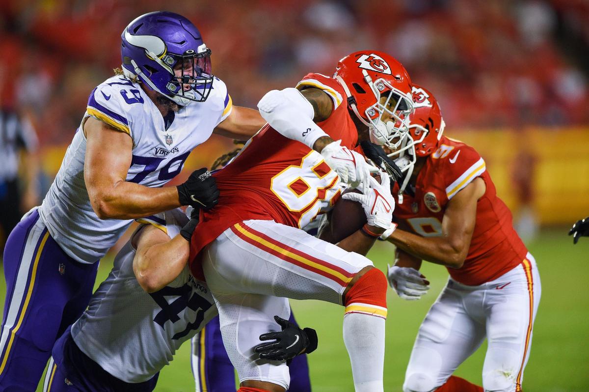 Minnesota defensive end Kenny Willekes (79) tries to stop Kansas City Chiefs tight end Jody Fortson (88) who ran for a gain during the second half of game action against the Vikings on Friday, Aug. 27, at Arrowhead Stadium in Kansas City.