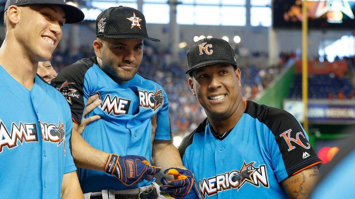 Houston Astros shortstop Carlos Correa (back) and Kansas City Royals catcher Salvador Perez (13) pick up Houston Astros second baseman Jose Altuve (27) during the 2017 MLB All-Star Game at Marlins Park on July 11, 2017 in Miami.