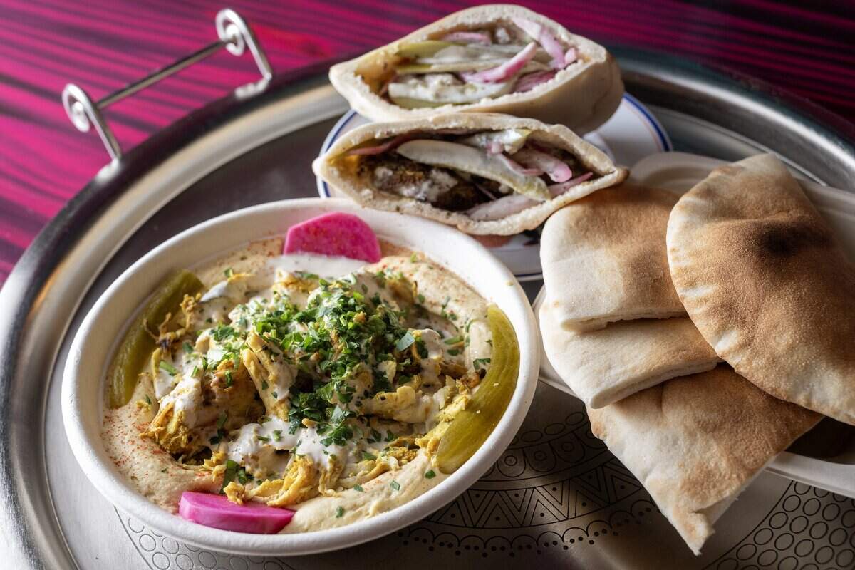 Baba's Hummus Platter with chicken shawarma and the Falafel pita sandwich at Baba's Pantry, 1019 E. 63rd St., on Tuesday, May 19, 2026, in Kansas City. The hummus is made fresh in-house daily.