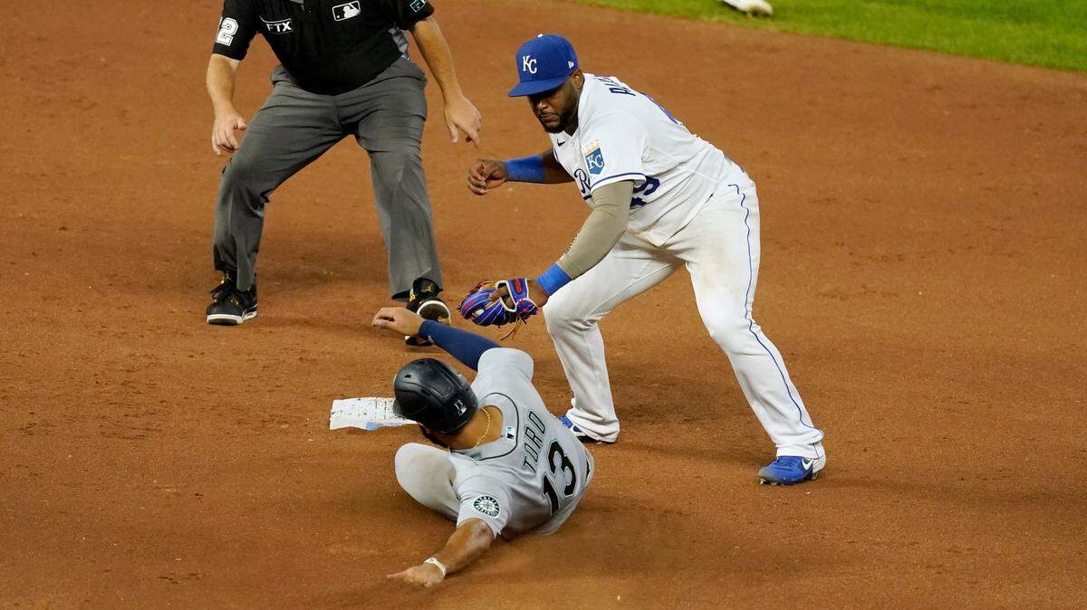 Kansas City Royals third baseman Hanser Alberto gets the second out of a double play on the Seattle Mariners’ Abraham Toro at second during the sixth inning on Friday, Sept. 17, 2021, at Kauffman Stadium in Kansas City, Mo.