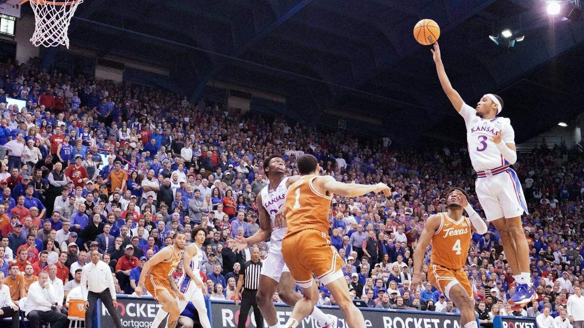 Kansas Jayhawks guard Dajuan Harris shoots a floater as Texas Longhorns forward Dylan Disu defends during the first half at Allen Fieldhouse on Feb. 6, 2023.