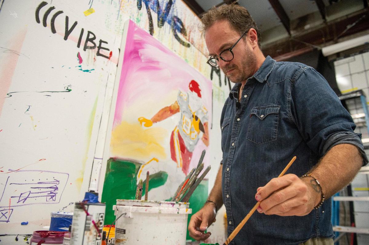 John Bukaty works on a painting of Travis Kelce at Bukaty’s studio in New Orleans. Bukaty once played football at KU and lived in Kansas City.