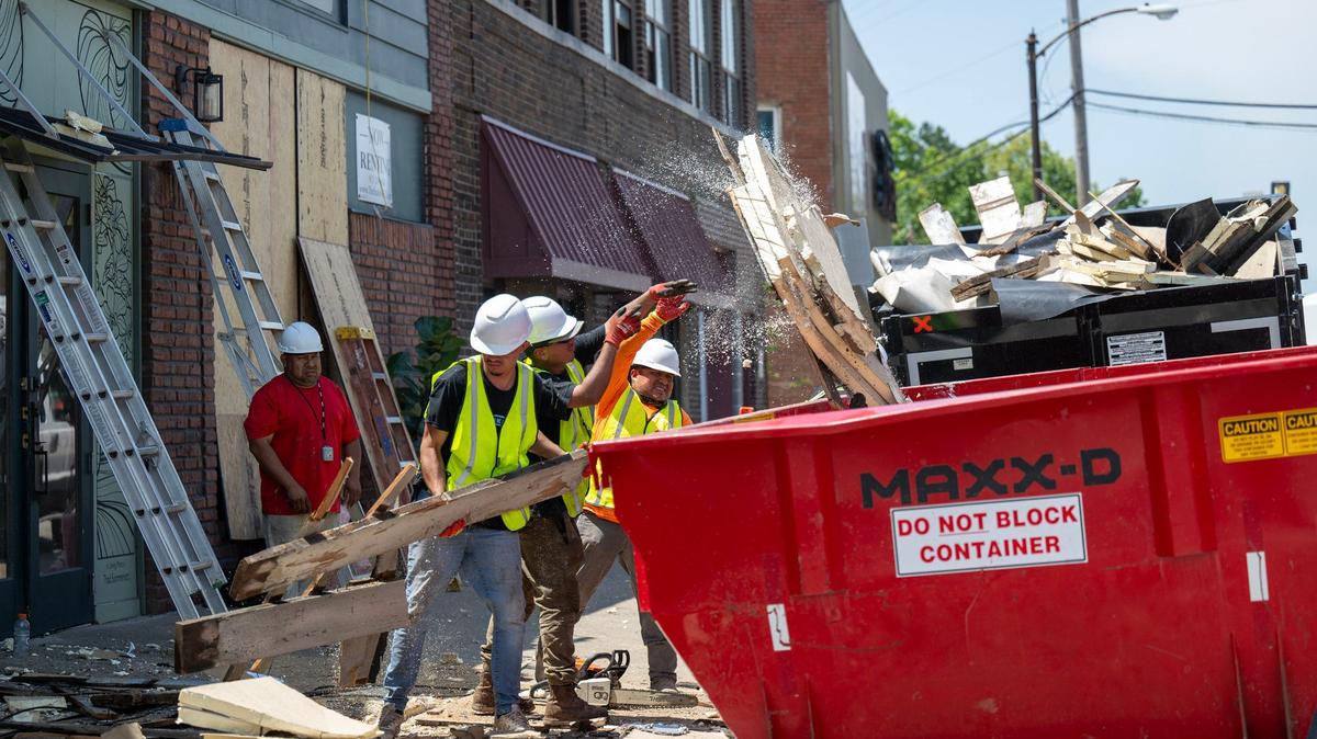 Workers clean up Monday, May 20, 2024, after a powerful thunderstorm Sunday night ripped the roof off the Central Avenue Betterment Association (CABA) building, 1303 Central Ave., in Kansas City, Kansas. The 120 year old building sustained heavy damage.
