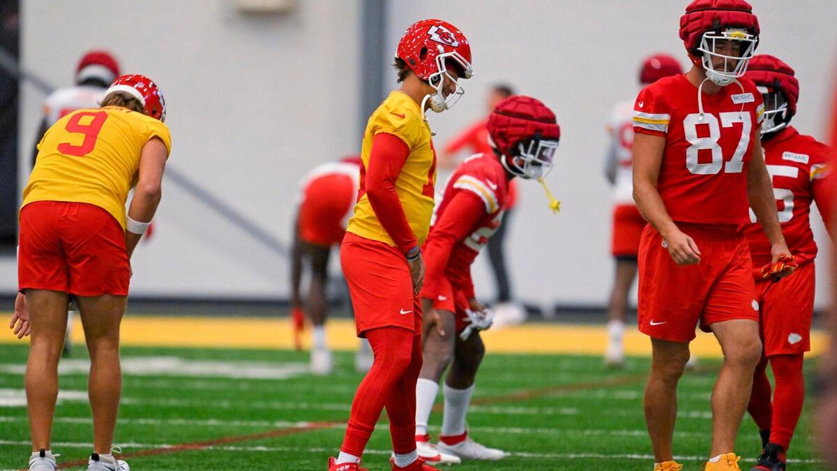Chiefs quarterback Patrick Mahomes (87) and tight end Travis Kelce (87) warm up during training camp indoors at Missouri Western State University on Wednesday, Aug. 9, 2023, in St. Joseph, Missouri.