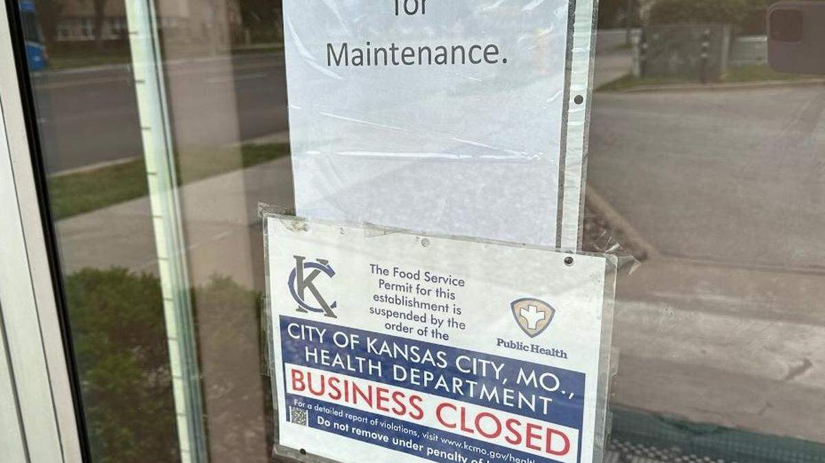 Two signs on the door of the Plaza area Winstead’s