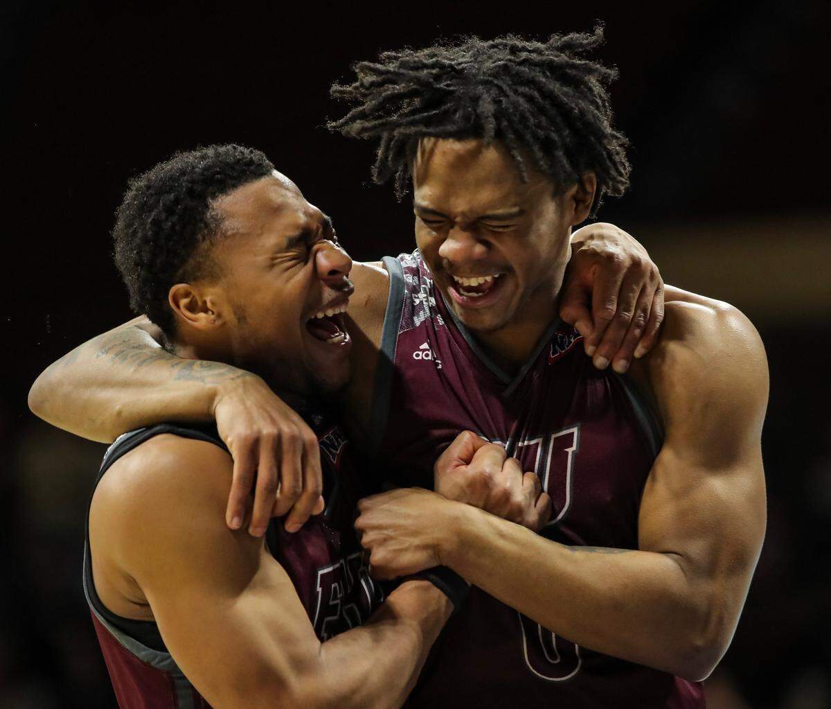 JJ Wheat, left, and Quan Lax celebrate Freed-Hardeman’s first NAIA national championship in program history at Municipal Auditorium. The Lions erased a six-point deficit with 45 seconds remaining to win 71-67 over Langston University on March 26, 2024.