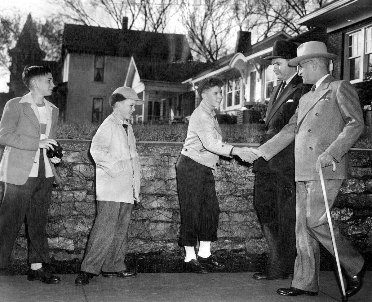 Young Independence students meet President Harry S. Truman as he walks near his home in 1945. From left, Jimmy Zimmerman, 13, waits with a camera; Jimmy Brand, 12, moves closer and Junior Dulas, 14, reaches for a handshake. The boys attended Bryant School. A Secret Service agent accompanies the president.