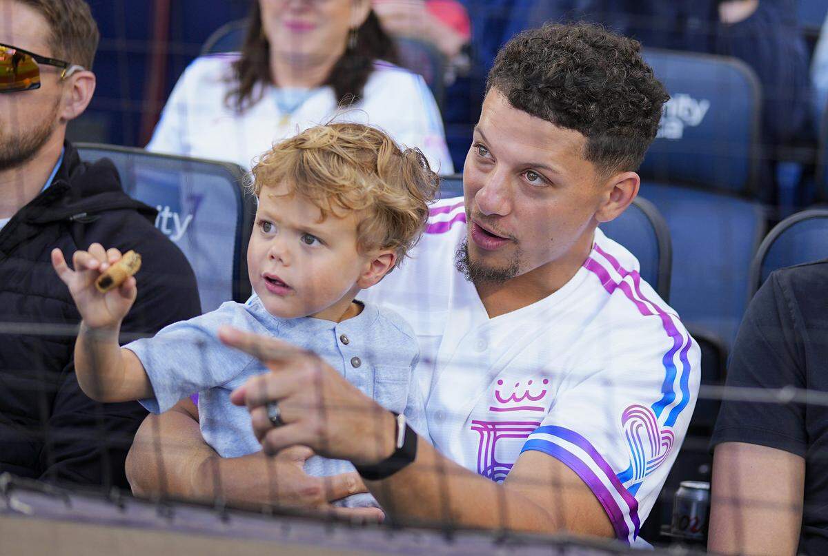 Chiefs quarterback and Royals part-owner Patrick Mahomes watches a game against the Detroit Tigers with son Bronze on Friday, May 8, 2026 at Kauffman Stadium in Kansas City.