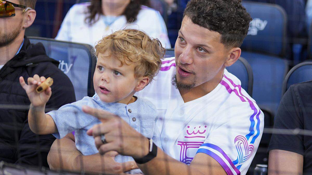 Chiefs quarterback and Royals part-owner Patrick Mahomes watches a game against the Detroit Tigers with son Bronze on Friday, May 8, 2026 at Kauffman Stadium in Kansas City.