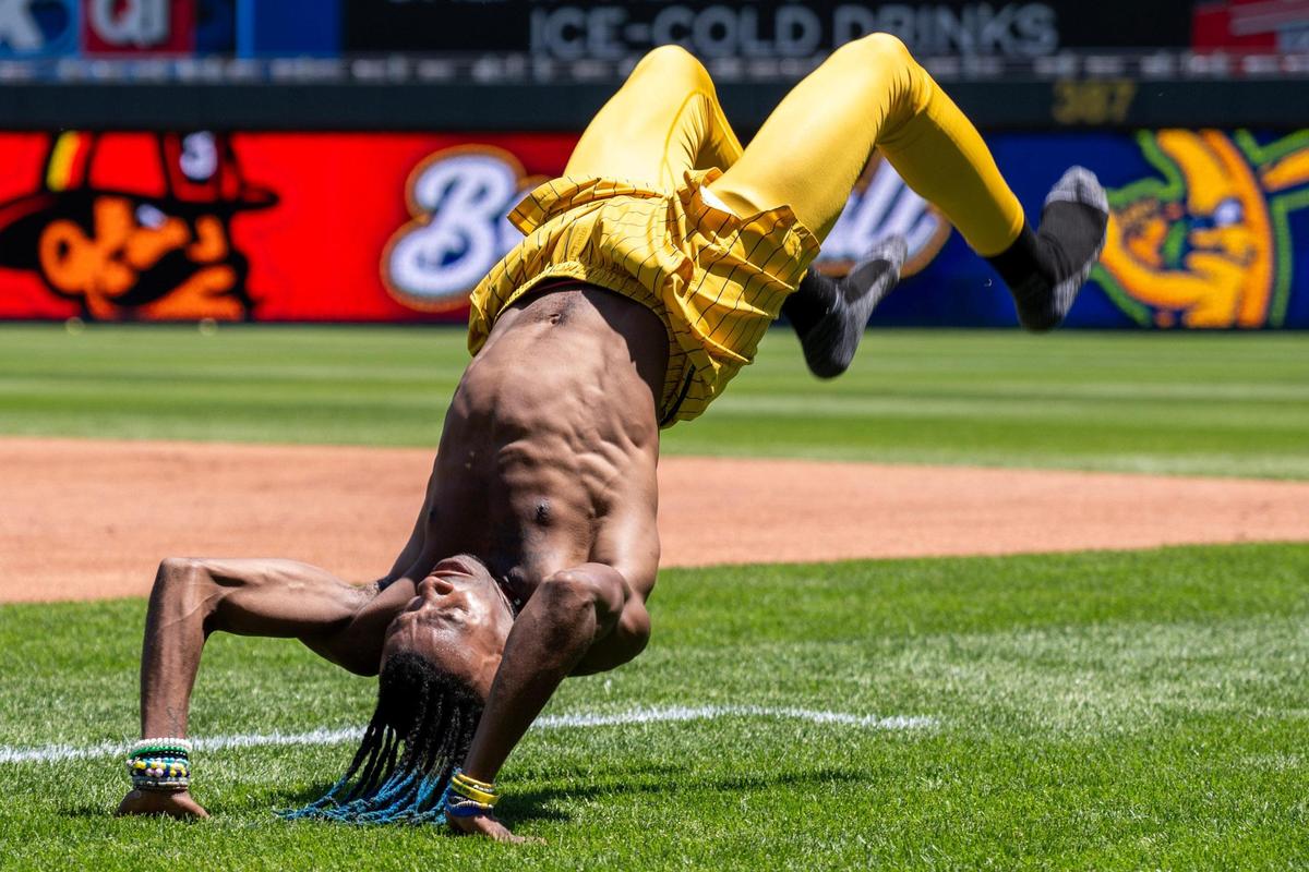 Savannah Bananas dancing base coach Maceo Harrison, performs a backflip while warming up during practice before a Banana Ball game against the Firefighters at Kauffman Stadium on Friday, May 23, 2025, in Kansas City.
