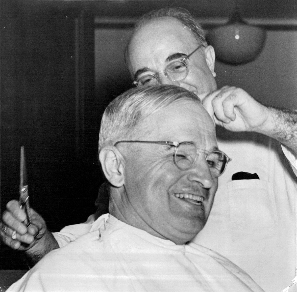 Barber Frank Spina cuts President Harry S. Truman’s hair in 1945. Spina, a longtime friend, rushed to meet the president’s call for a trim.