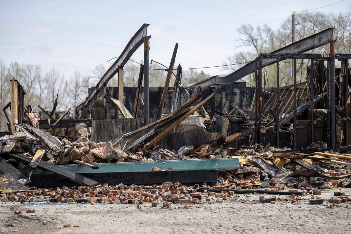 The skeletal remains of a Smithville shopping center stand in ruin on Tuesday, March 31, 2026, less than 24 hours after a massive fire destroyed five businesses. The Monday afternoon blaze destroyed Smithville's Pizza Shoppe, La Fuente Mexican Restaurant, H&R Block, Westlake Chinese Restaurant, and Lakeside Smoke.