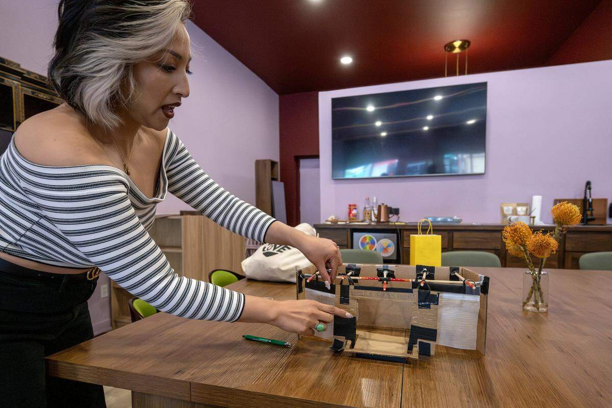 Béty Lê Shackelford, founder and executive director of Hella Good Deeds, showcases a diorama of Hella Good Deeds during a tour on Friday, May 8, 2026, in Kansas City.