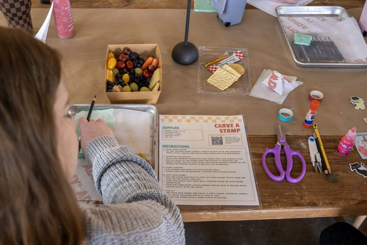Megan Berberish reads instructions to make a carved stamp at ADHDIY Craft Cafe on Saturday, Feb. 7, 2026, in Kansas City.