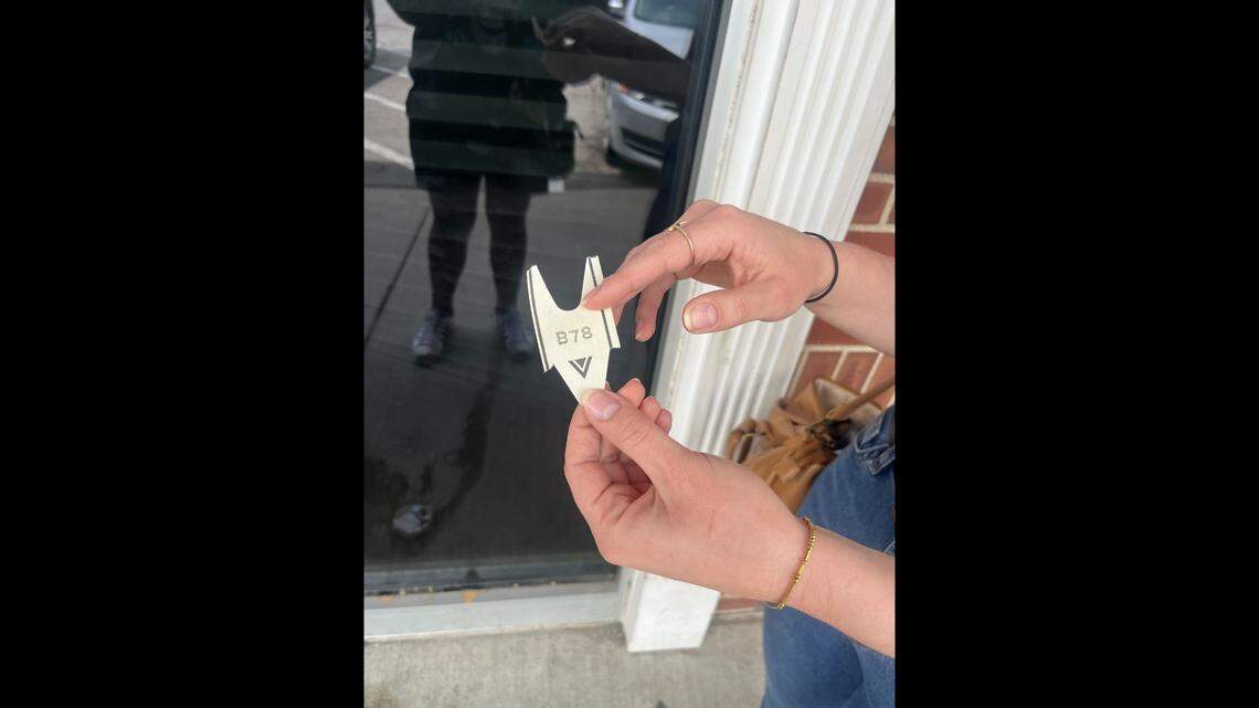 Andrea Cady from the Volker neighborhood shows her ticket she received at the Kansas City DMV, 1161 Emanuel Cleaver II Blvd., Tuesday, May 6. She used paid time off from work to get her Real ID.