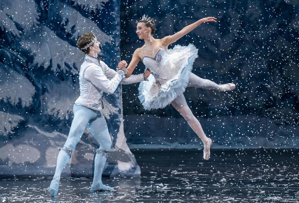 Fifty pounds of specially cut paper “snow” falls from above the stage every time Kingdom of the Snow scene is performed in the “The Nutcracker” at the Kauffman Center. Dancers Paul Zusi and Sidney Haefs perform through the scene as the Snow King and Snow Queen during the final dress rehearsal on Dec. 4, 2024.