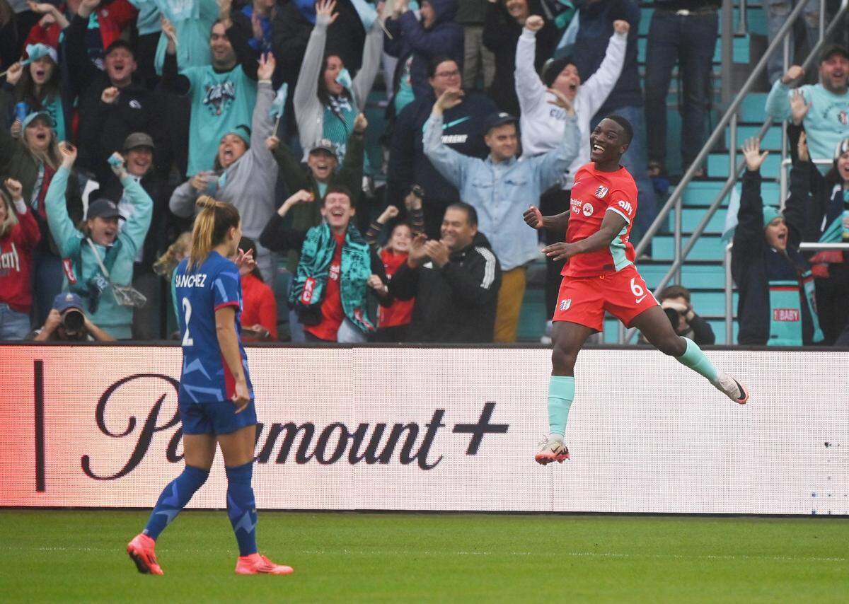 Kansas City Current forward Temwa Chawinga, right (in midair), celebrates at CPKC Stadium on Saturday, Nov. 9, 2024, after scoring an NWSL playoff goal against the North Carolina Courage.