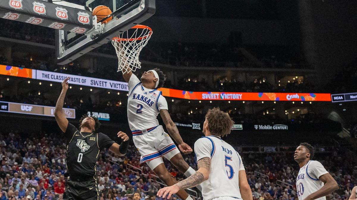 Kansas Jayhawks guard AJ Storr (2) shoots inside as UCF Knights guard Jordan Ivy-Curry (0) looks on in the first half at the Big 12 Tournament at T-Mobile Center on Wednesday, March 12, 2025, in Kansas City.