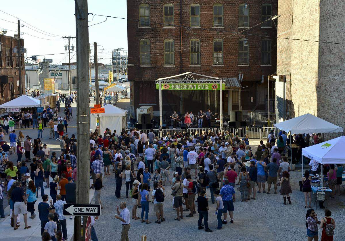 People listen to The Grisly Hand during the Boulevardia festival in Kansas City's West Bottoms on Friday, June 13, 2014.