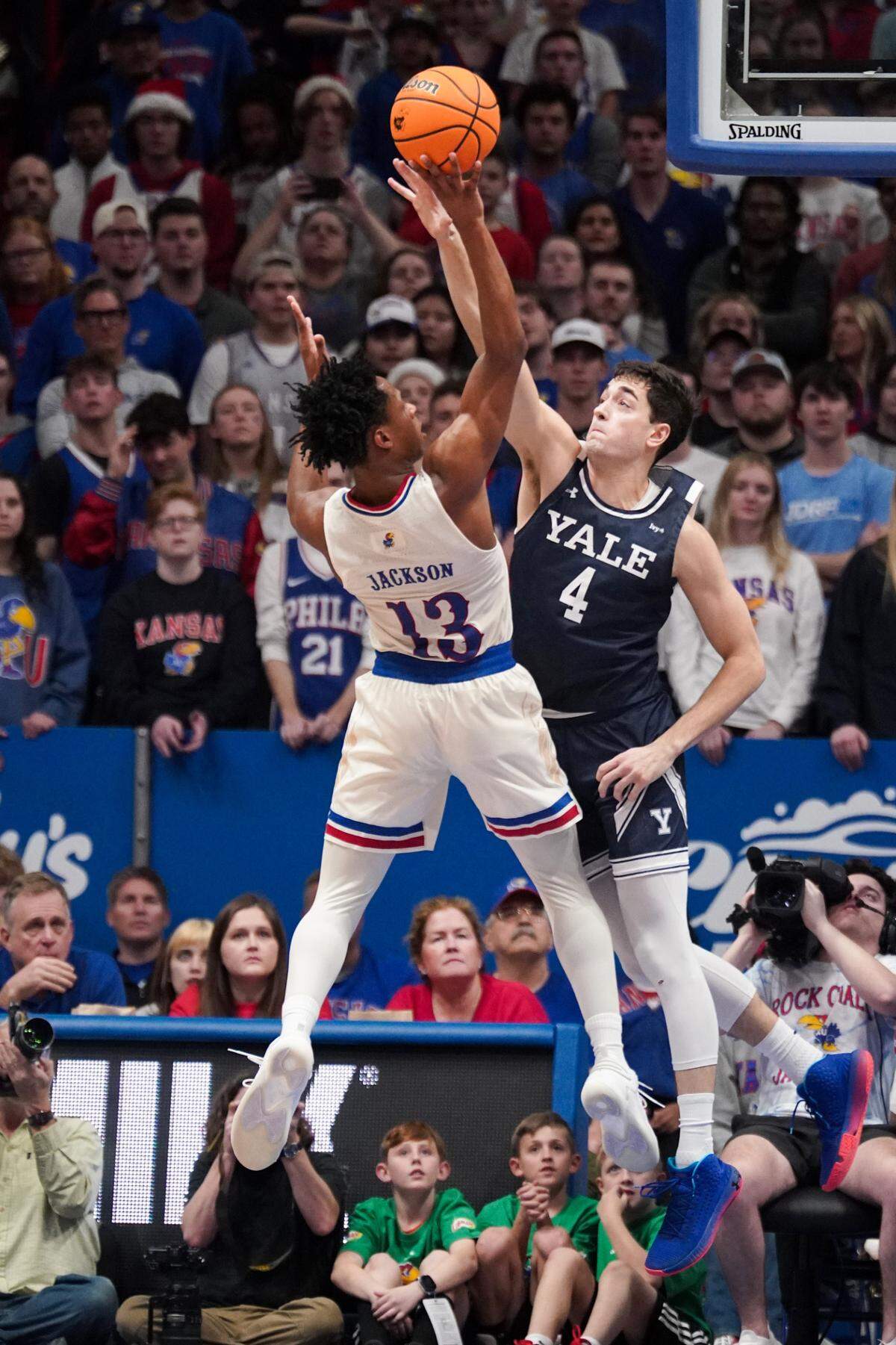 Kansas Jayhawks guard Elmarko Jackson (No. 13) shoots over Yale Bulldogs guard John Poulakidas during Friday night’s game at Allen Fieldhouse in Lawrence, Kan.
