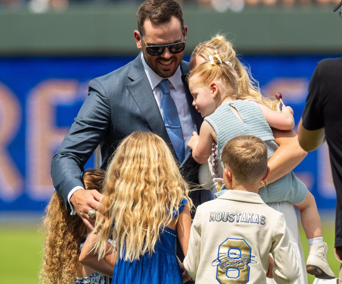 Mike Moustakas hugs his family after giving his retirement speech on Saturday, May 31, 2025 at Kauffman Stadium. Moustakas officially retired as a Royal after a 12-year career in Major League Baseball.