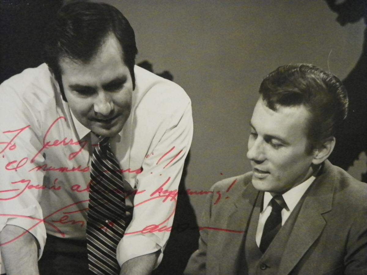 An autographed photo of Jerry Plantz and Len Dawson working in the news station.