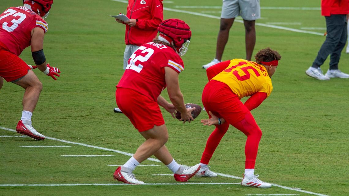Kansas City Chiefs quarterback Patrick Mahomes switches positions with center Creed Humphrey during warm-ups at Chiefs training camp on Thursday, July 28, 2022, in St. Joseph.