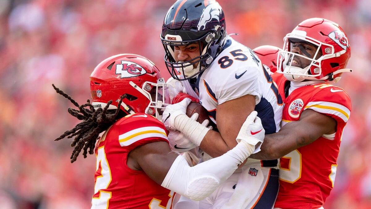 Kansas City Chiefs cornerback Jaylen Watson (35) and linebacker Nick Bolton (32) wrap up Denver Broncos tight end Albert Okwuegbunam (85) during an NFL football game at GEHA Field at Arrowhead Stadium on Sunday, Jan. 1, 2023, in Kansas City.