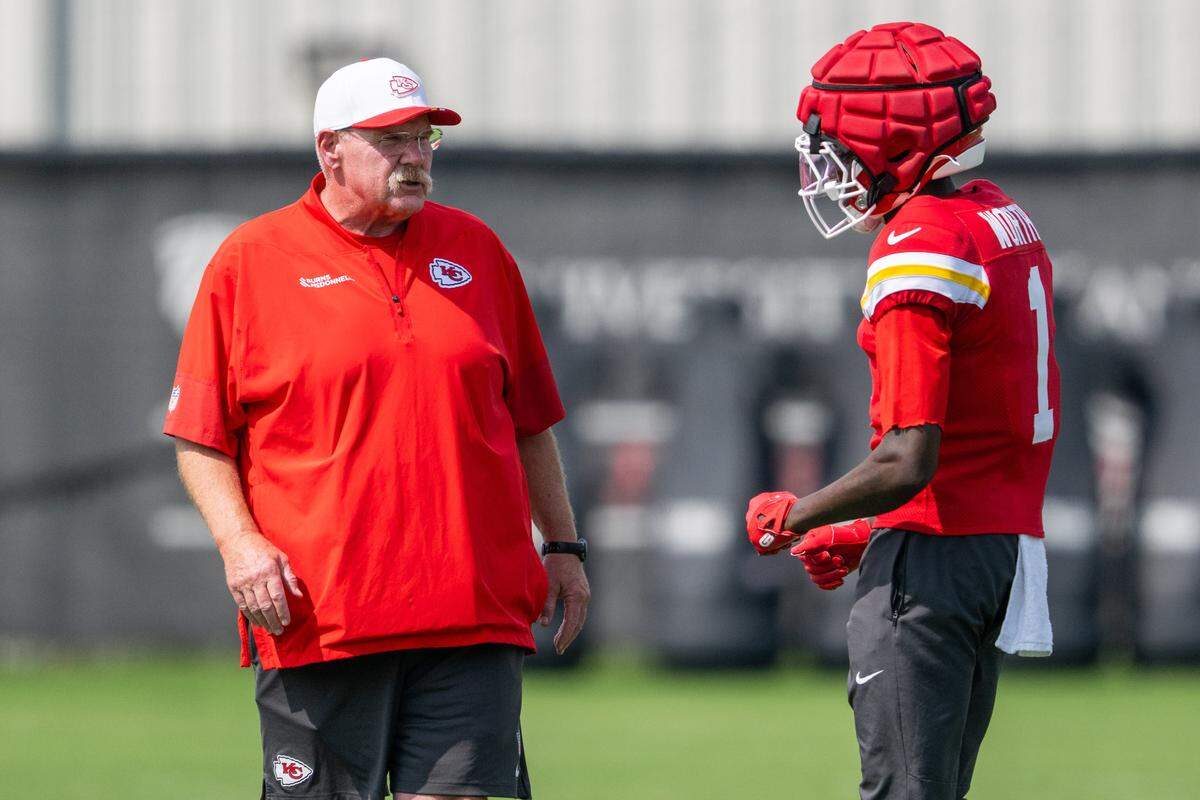 Kansas City Chiefs wide receiver Xavier Worthy (1) talks with Kansas City Chiefs head coach Andy Reid during practice drills at Chiefs practice on Wednesday, Sep. 17, 2025, in Kansas City.