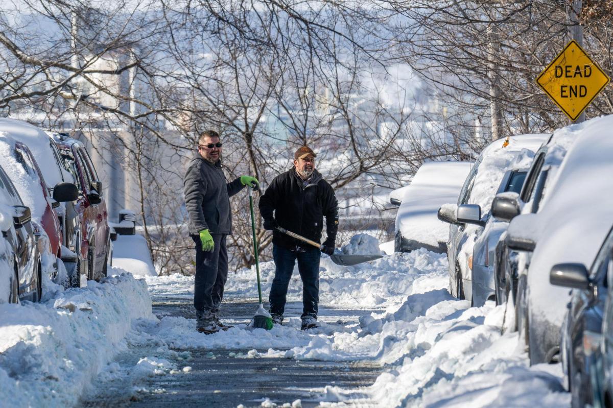 Victor Mendez and Cristo Mora help dig out each other’s vehicles in Kansas City on Monday, Jan. 6, 2025. Following the major storm on Jan. 5, several neighborhoods remained stuck in the snow.