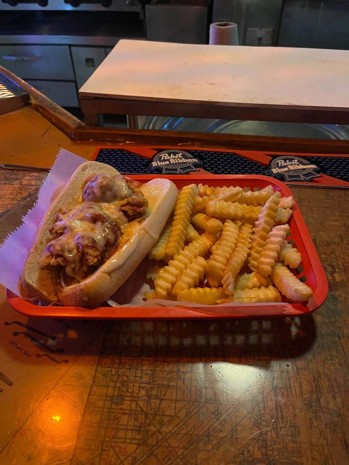 Grinders sells a chicken parmesan sandwich for $11.99. It’s $2.99 extra to upgrade to fries for the side.