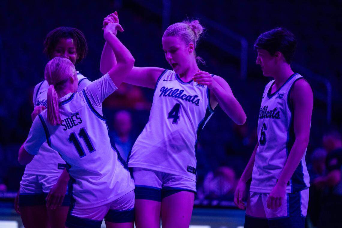 Kansas State guard Taryn Sides (11) bumps hips with forward Nastja Claessens (4) during player introductions prior to the Wildcats’ first-round game vs. the Cincinnati Bearcats in the Big 12 Women’s Basketball Tournament on Wednesday, March 4 at T-Mobile Center in Kansas City .
