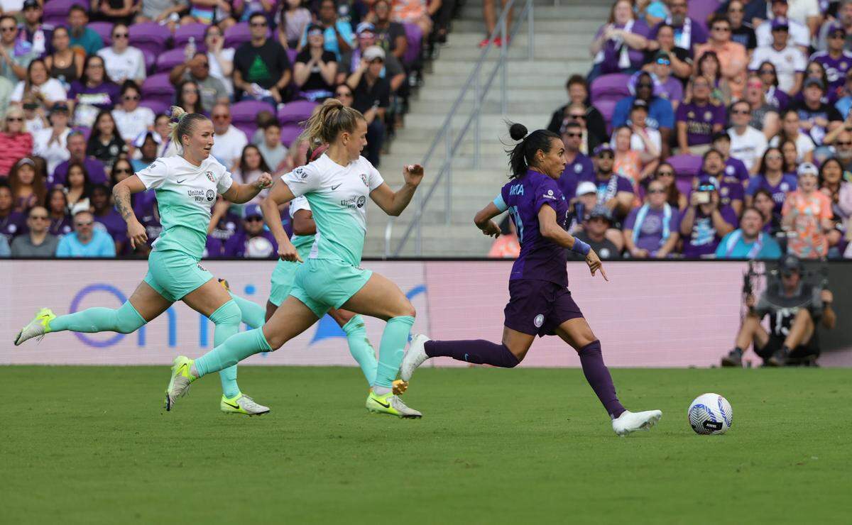 A trio of Kansas City Current players trail behind Orlando Pride forward Marta during an NWSL playoff semifinal soccer match at Inter&Co Stadium in Orlando on Sunday, Nov. 17, 2024.