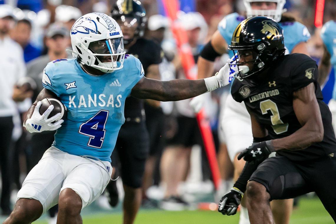 Kansas running back Devin Neal (4) attempts to bypass Lindenwood defensive back Jordan Knapke (2) during the game on Thursday, August 29, 2024 at Children’s Mercy Park in Kansas City, Kansas.