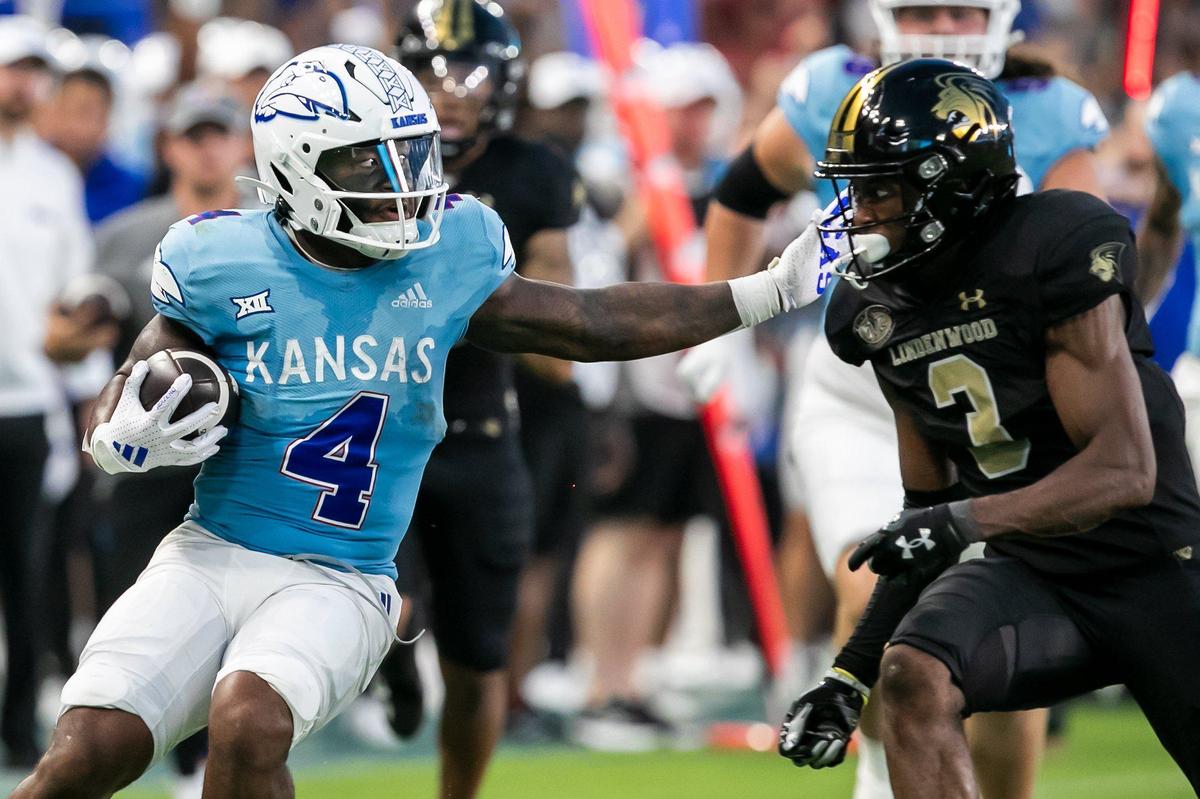 Kansas running back Devin Neal (4) attempts to bypass Lindenwood defensive back Jordan Knapke (2) during the game on Thursday, August 29, 2024 at Children’s Mercy Park in Kansas City, Kansas.
