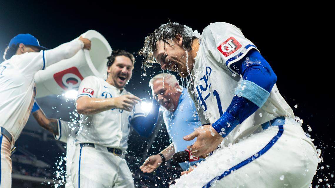 Kansas City Royals designated hitter Vinnie Pasquantino (9), shortstop Bobby Witt Jr. (7) and broadcaster Joel Goldberg are doused by captain Salvador Perez (13) and left fielder MJ Melendez (1) after defeating the Boston Red Sox at Kauffman Stadium on Aug. 7, 2024.