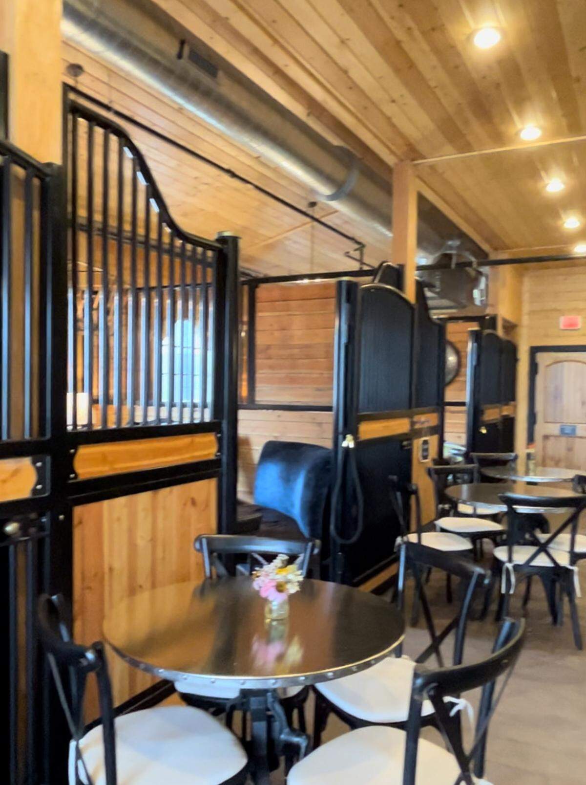 The revamped barn, which opened for wine tasting in 2020, has kept its rural feel. Customers can enjoy their drinks inside horse stables.