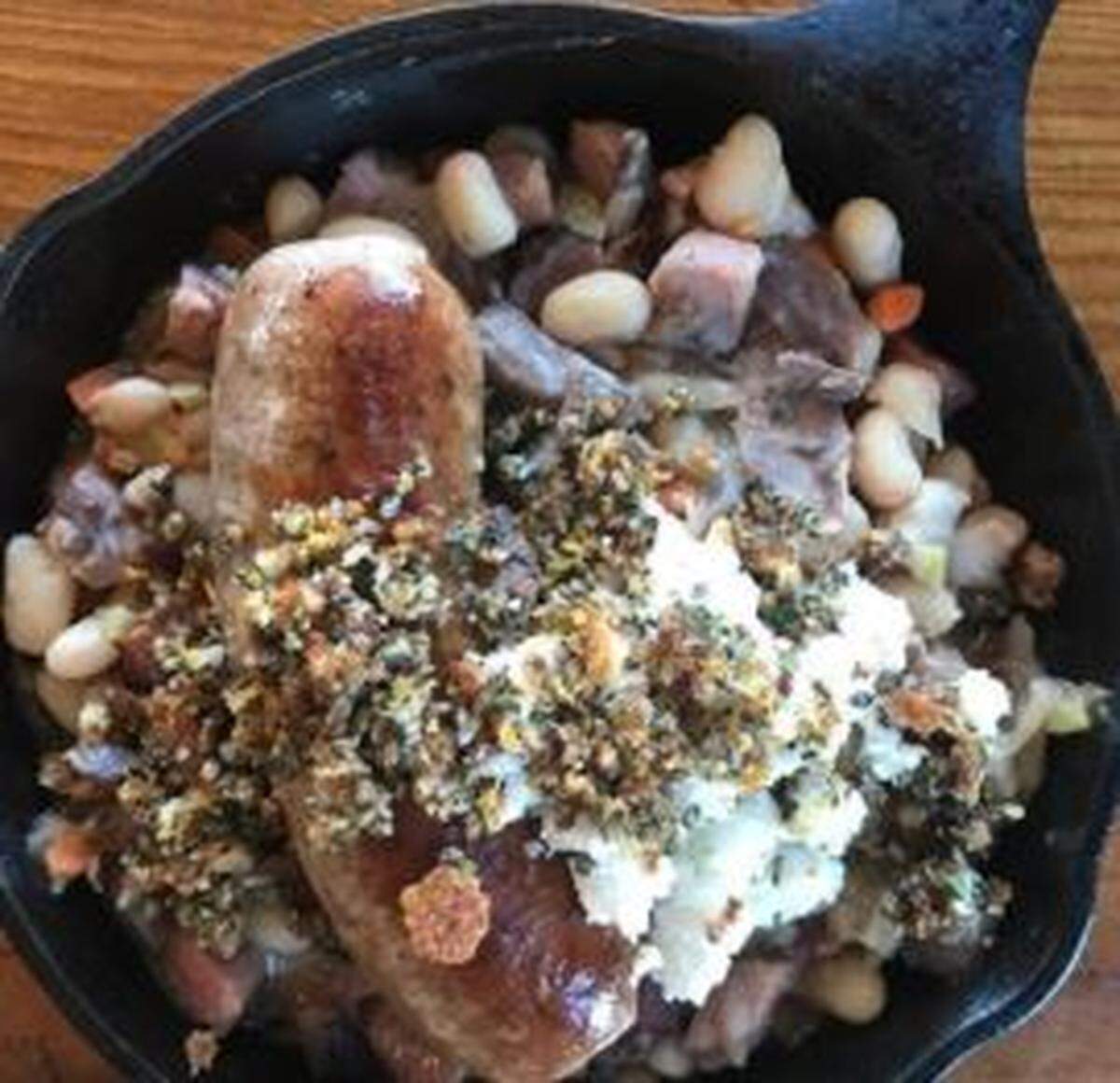 Fox and Pearl’s cassoulet with house sausage, braised pork shoulder, bacon, Kansas white beans and gremolata - to re-heat or freezer ready. It comes with a house salad.