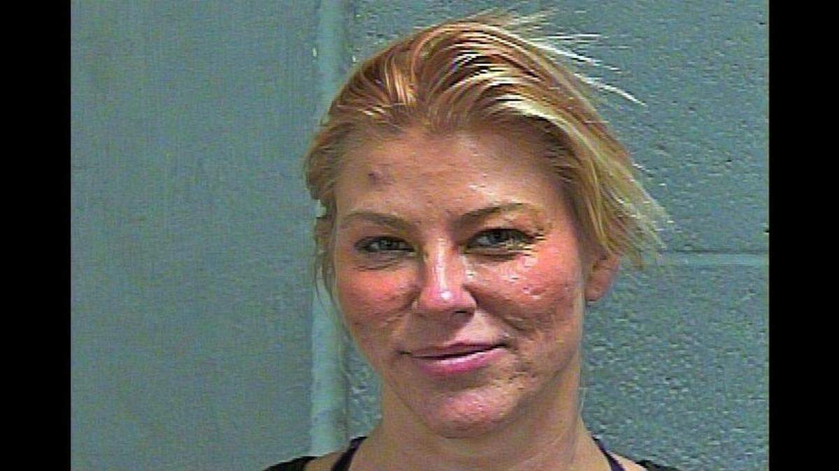 Candace Muzny, 43, was arrested after Oklahoma police say she attacked a nail salon worker for not speaking English.