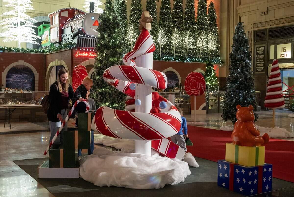 Visitors to the media preview tried out the holiday slide as final touches were being put on “Holiday Reflections” at Union Station on Thursday, November 20, 2025, in Kansas City.