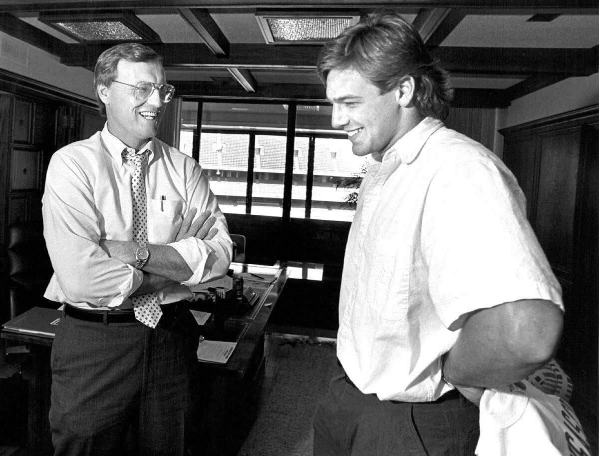 Chiefs Coach Marty Schottenheimer (left) chatted with his newest quarterback, No. 2 pick Mike Elkins of Wake Forest, at Arrowhead Stadium. Schottenheimer served as head coach of the Kansas City Chiefs from 1989 to 1998, compiling a 101–58–1 regular season record. During his tenure, the Chiefs won three division titles, made seven playoff appearances, and reached the AFC Championship Game in 1993, where they were defeated by the Buffalo Bills.
