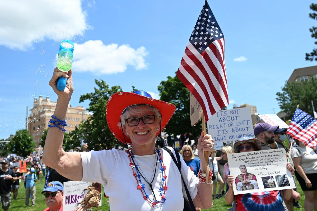 Loretta Rood used a bubble gunduring the “No Kings” rally Saturday, June 14, 2025, at Mill Creek Park in Kansas City.