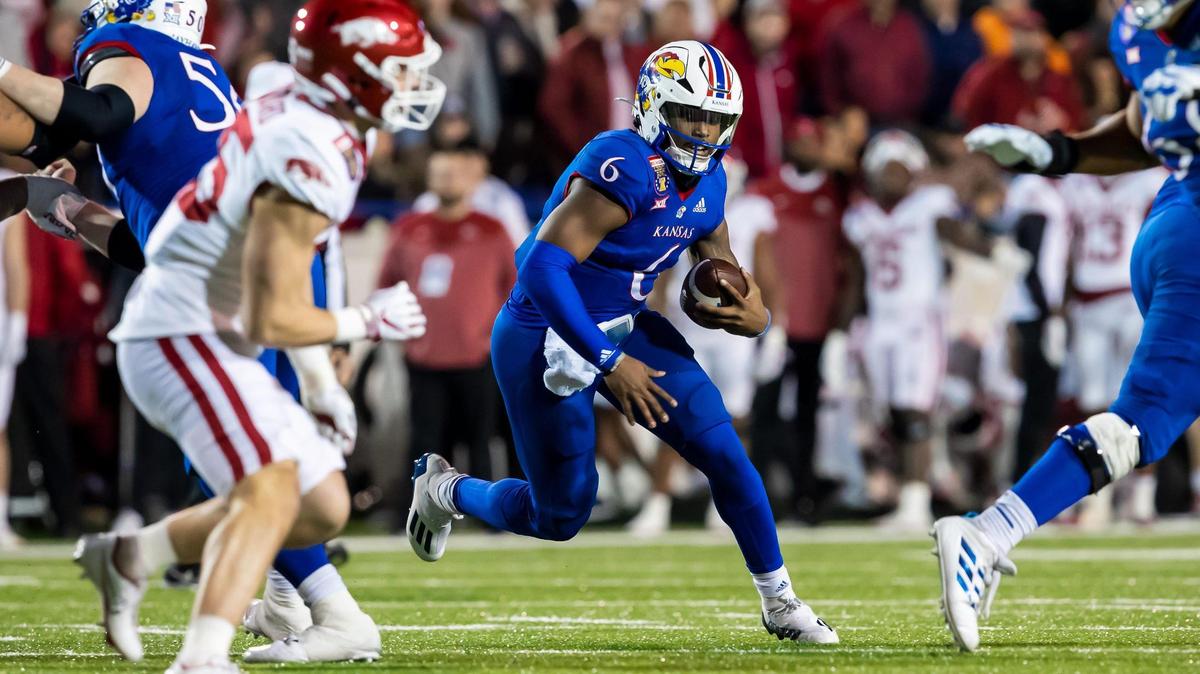 Jayhawks quarterback Jalon Daniels scrambles through an opening during the Liberty Bowl game between the Kansas Jayhawks and Arkansas Razorbacks on Wednesday, December 28, 2022, in Memphis, Tennessee.