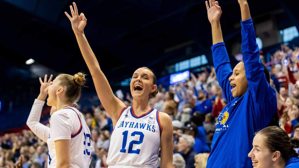 Kansas forward Katrine Jessen (12) and teammates celebrate a three-pointer from the bench during the second round of the Women’s NIT game between the Kansas Jayhawks and Missouri Tigers on Saturday March 20, 2023.