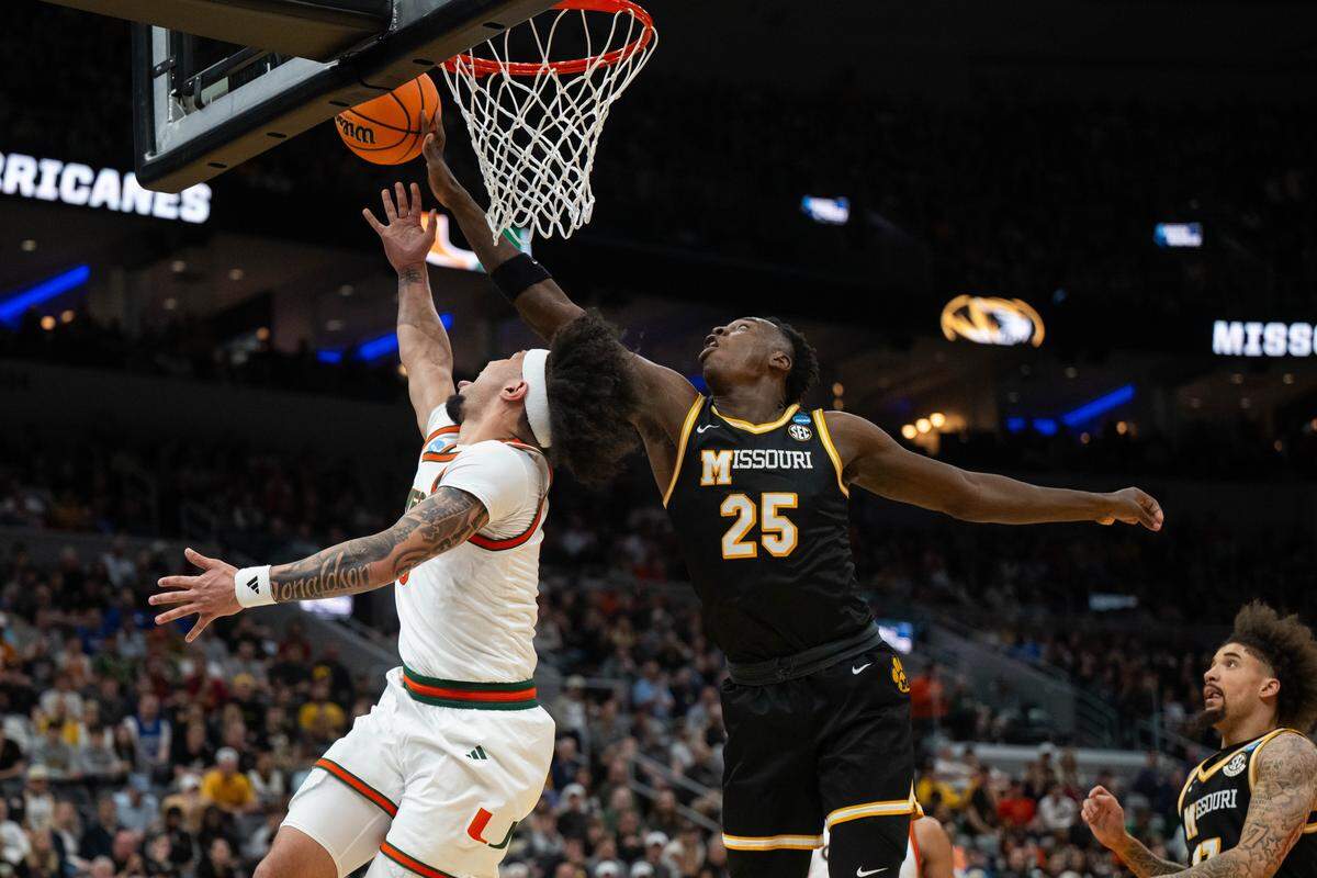Missouri forward Mark Mitchell (25) blocks a layup by Miami guard Tre Donaldson (3) during the Tigers’ first-round NCAA Tournament loss to the Hurricanes at the Enterprise Center in St. Louis on Friday, March 20, 2026.