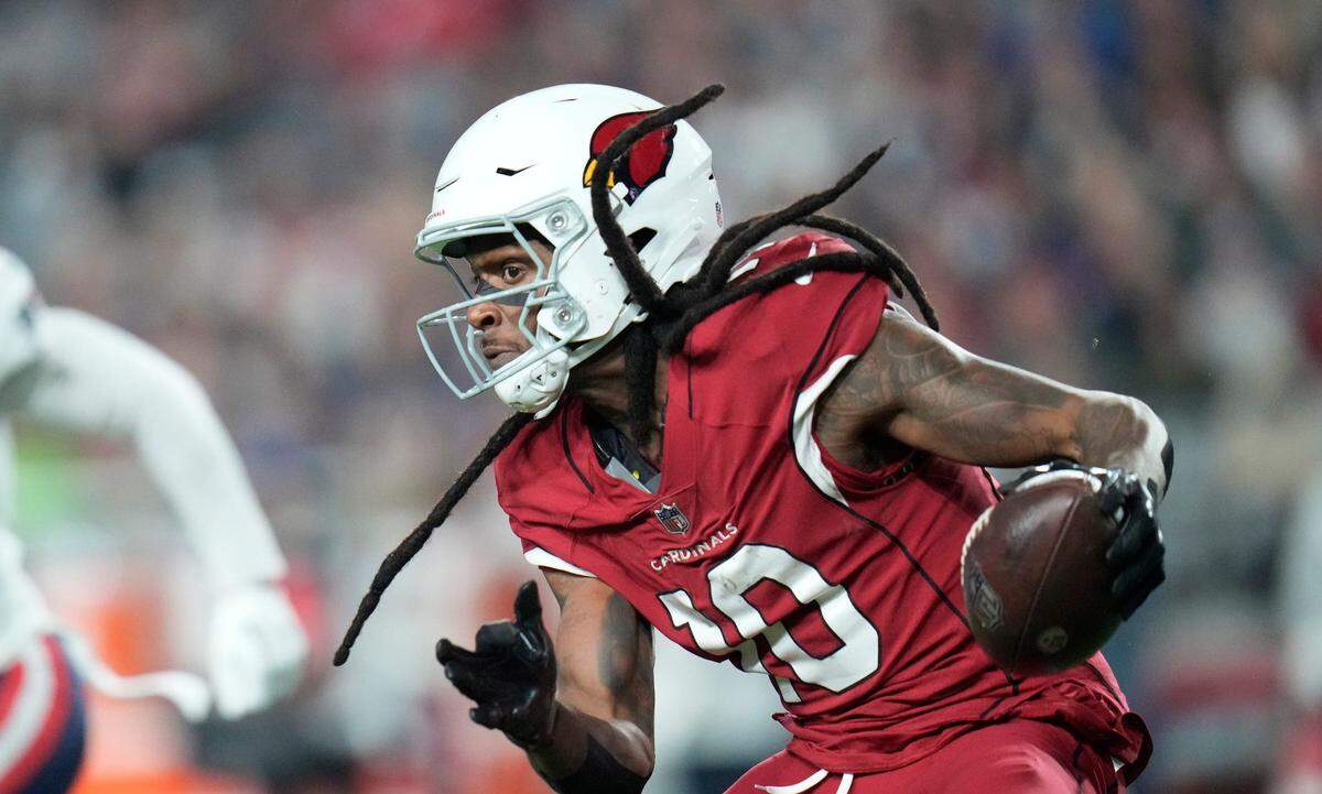 Dec 12, 2022; Glendale, Ariz., USA; Arizona Cardinals wide receiver DeAndre Hopkins (10) runs with the ball after a catch against the New England Patriots during the third quarter at State Farm Stadium.