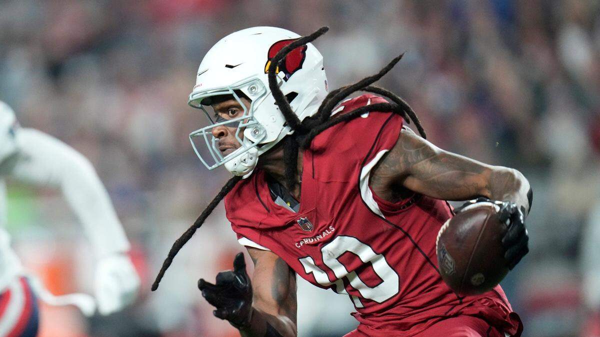 Dec 12, 2022; Glendale, Ariz., USA; Arizona Cardinals wide receiver DeAndre Hopkins (10) runs with the ball after a catch against the New England Patriots during the third quarter at State Farm Stadium.