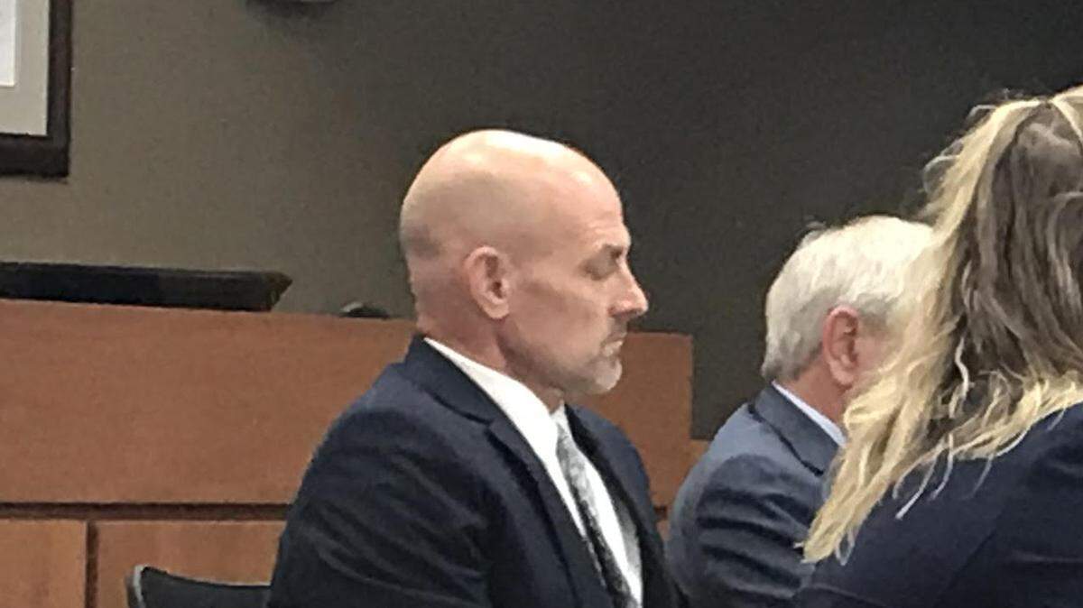 Joe Oswald, a Lee’s Summit physical education teacher and track and field coach, sat with his attorneys as he listened during a hearing regarding his use of a racial slur.