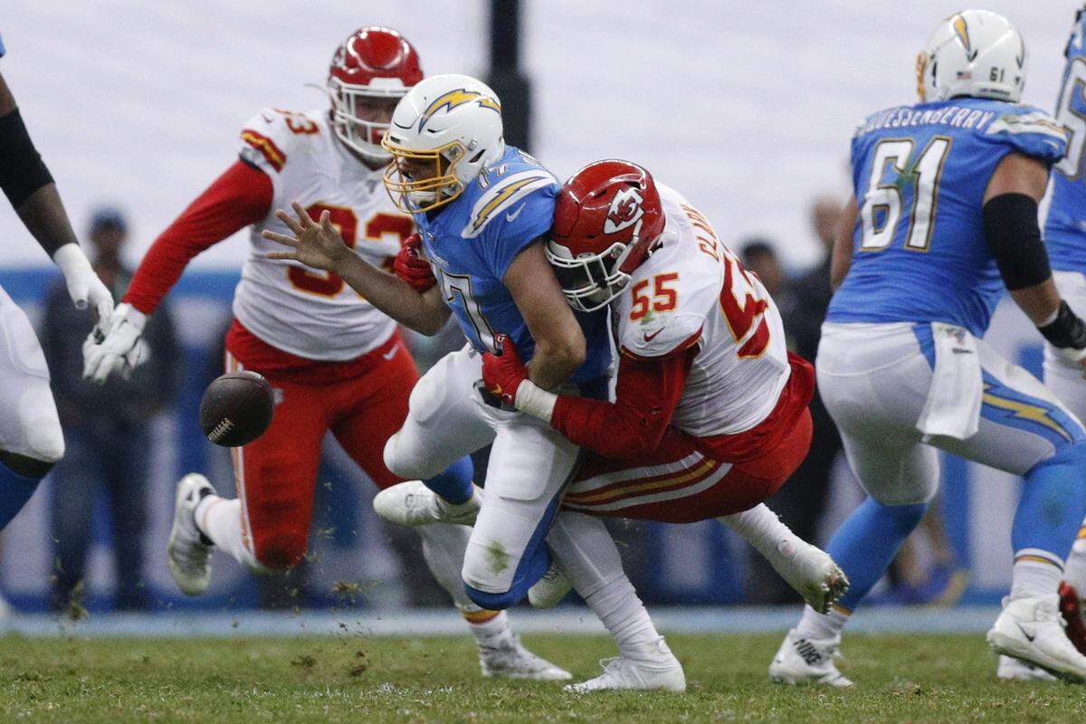 Los Angeles Chargers quarterback Philip Rivers, center, is sacked by Kansas City Chiefs defensive end Frank Clark (55) and defensive tackle Joey Ivie (93) during the second half of an NFL football game Monday, Nov. 18, 2019, in Mexico City.