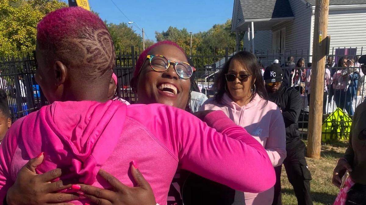 Lonnie Bush, founder of Celebration of Life nonprofit, seen at community event raising awareness about cancer and embracing a fellow survivor.